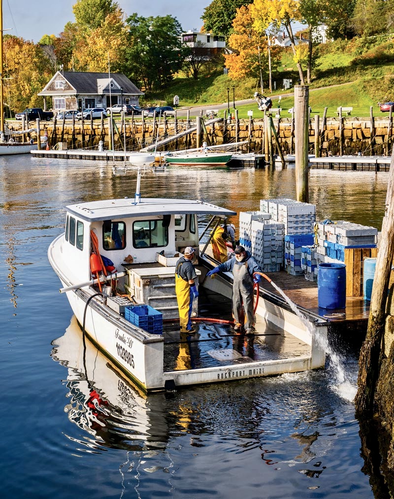 lobster boat in maine during the fall foliage season